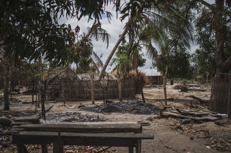 Destroyed houses are seen in the recently attacked village of Aldeia da Paz outside Macomia in the Cabo Delgado province of Mozambique on Aug. 24, 2019. On Aug. 1, 2019, the inhabitants of Aldeia da Paz joined the long list of victims of a faceless Islamist group that has been sowing death and terror for nearly two years in the north of the country. | AFP via Getty Images/MARCO LONGARI