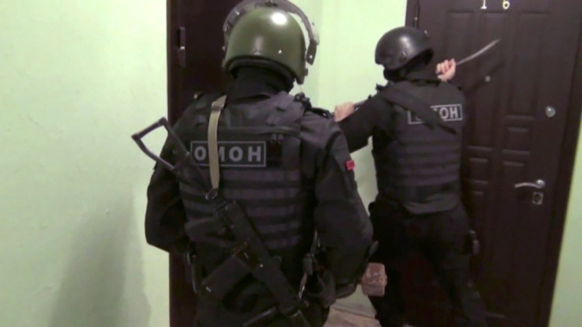 Russian police prepare to conduct a raid