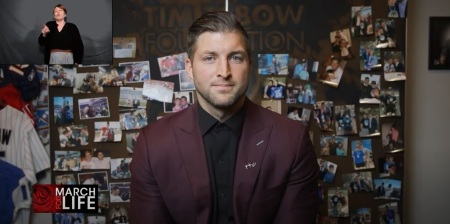 Former National Football League player Tim Tebow speaks at the virtual March for Life in Washington, D.C., with a sign language interpreter present in a separate live feed, on Friday, Jan. 29, 2021.