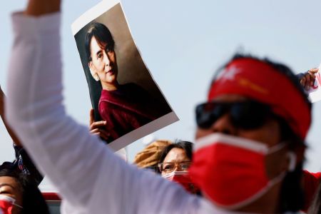 A group of Myanmar activists residing in Israel hold up a portrait of ousted leader Aung San Suu Kyi as they chant slogans during a protest outside the country's embassy in the Mediterranean coastal city of Tel Aviv on February 3, 2021.