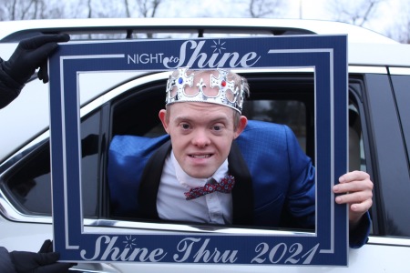 A Night to Shine-Thru individual wears a crown during the drive-thru event.