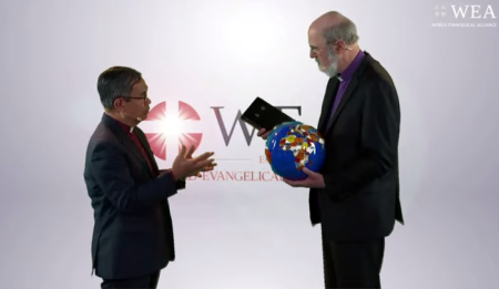 Outgoing Secretary-General Bishopp Efraim Tendero (left) hands over a globe and a Bible to incoming Secretary-General Bishop Thomas Schirrmacher during a handover ceremony in Bonn, Germany on Feb. 27, 2020.