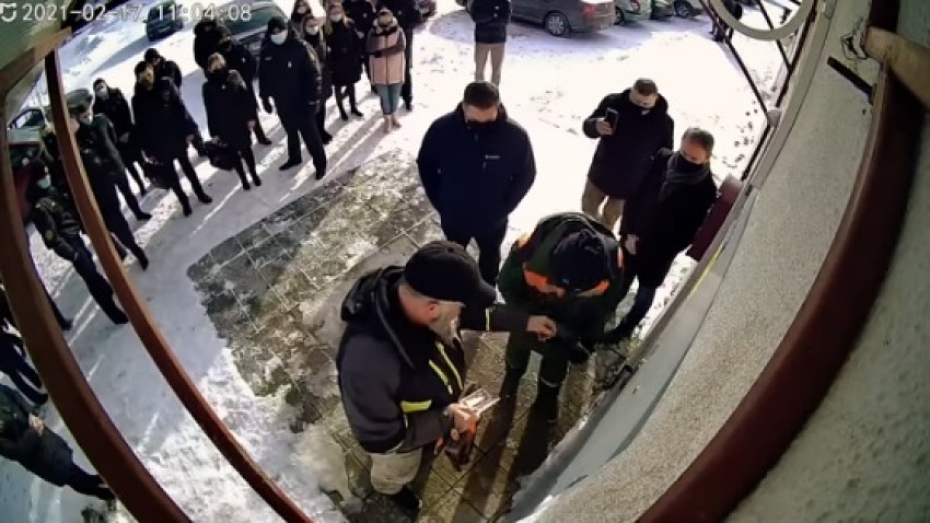 Authorities break a lock on the door of New Life Church in Minsk, Belarus on Feb. 17, 2017.