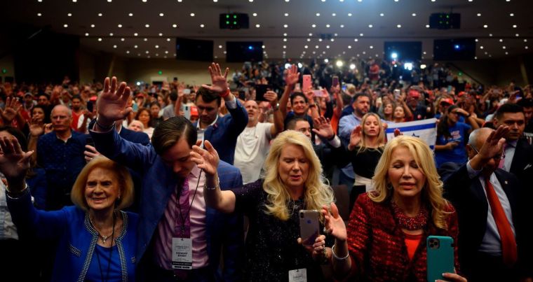 Supporters pray as President Donald Trump speaks during an 'Evangelicals for Trump' campaign event held at the King Jesus International Ministry on Jan. 3, 2020 in Miami, Florida. | AFP via Getty Images/Jim Watson