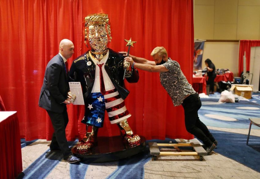 Matt Braynard (L) helps artist Tommy Zegan (R) move his statue of former President Donald Trump to a van during the Conservative Political Action Conference on February 27, 2021 in Orlando, Florida.