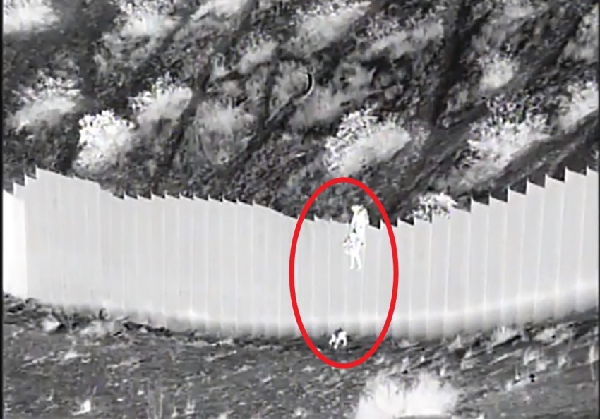 U.S. Border Patrol agents from the Santa Teresa Station in New Mexico rescue two toddlers dropped over a border barrier on March 30, 2021.