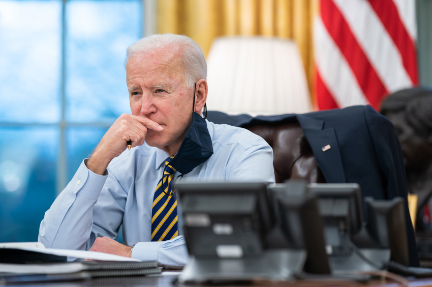 President Joe Biden participates in a conference phone call with governors affected by a snowstorm in the Midwest and southwest Feb. 16, 2021, in the Oval Office of the White House.