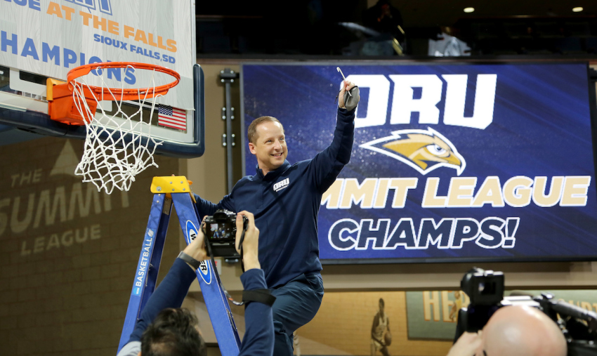 ORU Coach Paul Mills celebrates after being named the Summit League champions in Sioux Falls, South Dakota, on March 9, 2021.