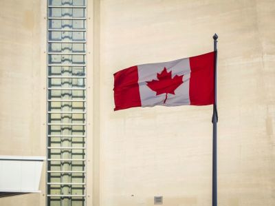 The Canadian flag flies outside the CN Tower in Toronto, Ontario, Canada.