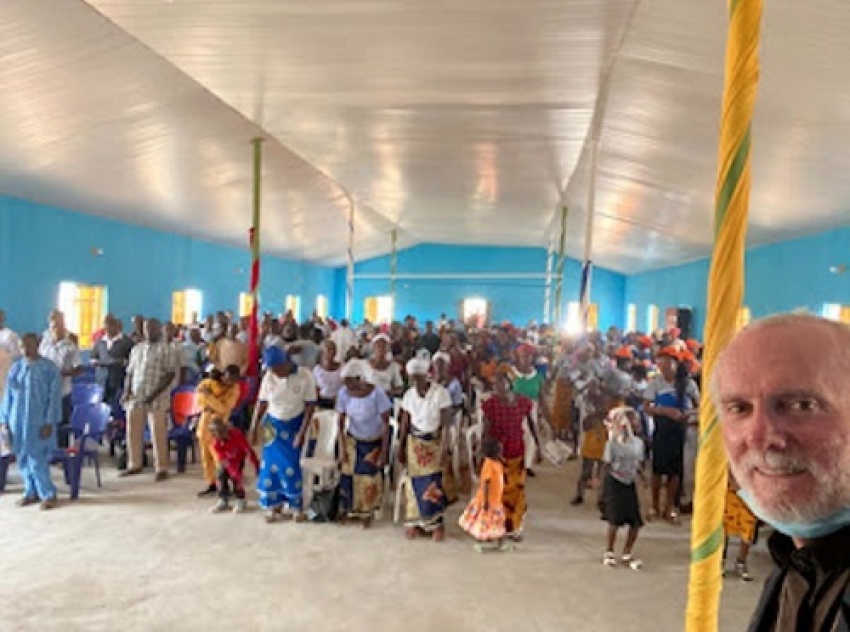 Pastor William Devlin poses with worshipers at the reopened Agatu Methodist Church in Benue state, Nigeria, on April 4, 2021, five years after it was destroyed.