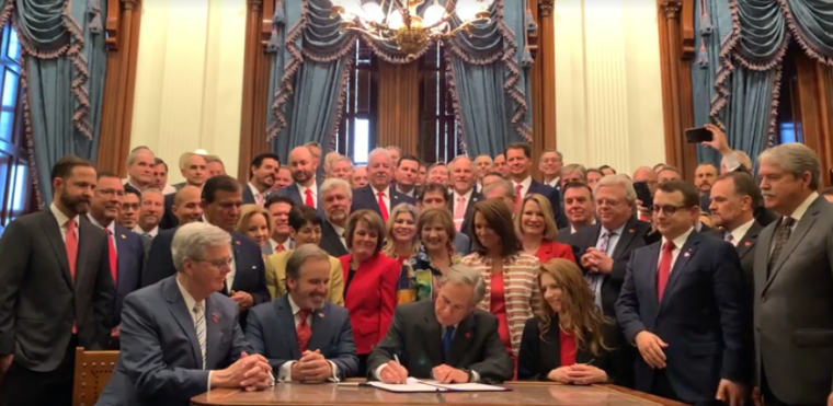 Greg Abbott signing Senate Bill 8