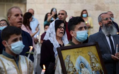 Palestinian Greek Orthodox worshippers chant as they attend the Easter morning mass at the church of Saint Porphyrius in Gaza City, on May 2, 2021. 