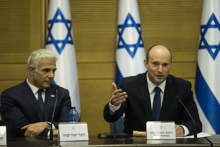 In coming Israeli Prime Minister Naftali Bennett (R) and Foreign Minister Yair Lapid attend the first meeting of the new government on June 13, 2021 in Jerusalem, Israel. The new government, a broad coalition of parties with a razor-thin majority, has ended the 12-year prime ministership of Benjamin Netanyahu.