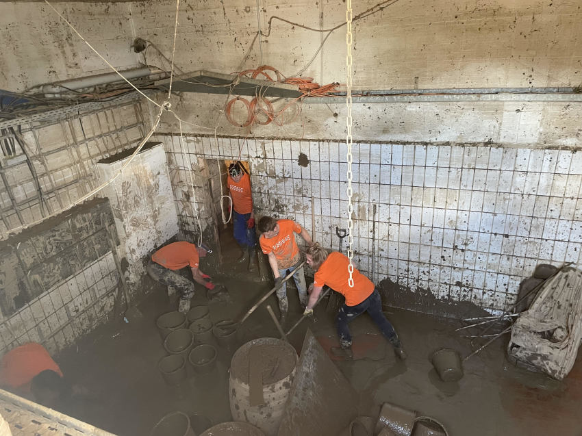 Volunteers from Samaritan's Purse work to help clean up the muddy water that flooded many buildings and homes after a natural disaster in Germany caused nearly 200 to drown to death in muddy water in July 2021.