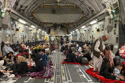 Afghan people sit inside a U.S. military aircraft at the military airport in Kabul on August 19, 2021, after Taliban's takeover of Afghanistan.