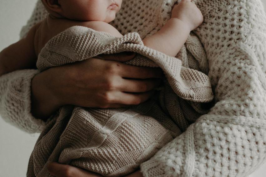 A mother holds her child.