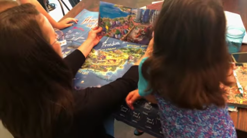 A woman reads a book published by Brave Books to children.