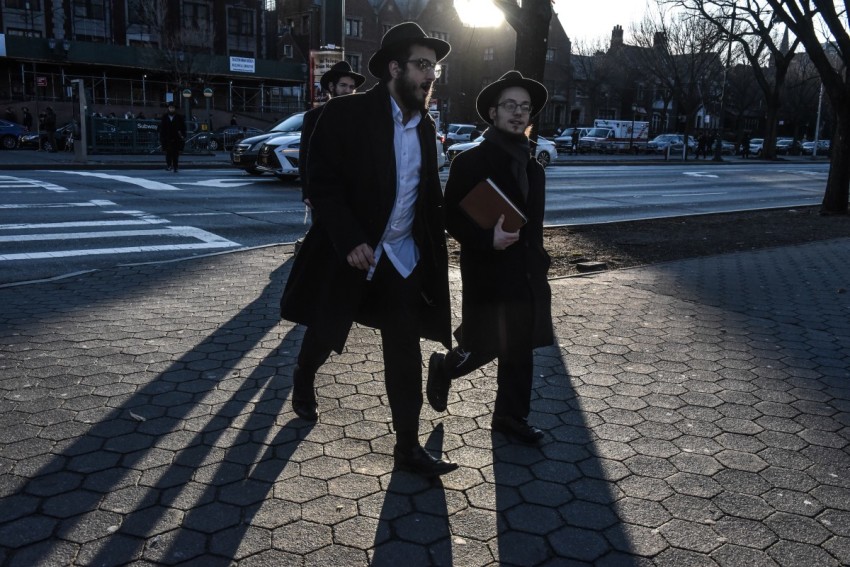Orthodox Jews walk through the neighborhood on December 31, 2019 in the Brooklyn borough of New York City. A coalition of religious and civil rights leaders were holding a #SafetyInSolidarity rally in Grand Army Plaza to speak out against recent anti-Semitic attacks.