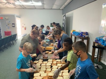 Members of the City Church in Del Rio, Texas, make sandwiches for Haitian migrants camped out under the International Bridge seeking entry into the United States.
