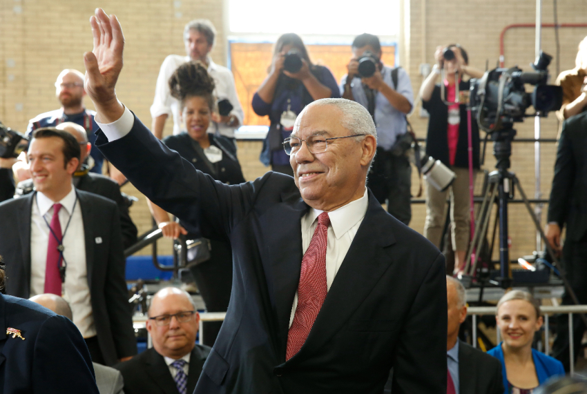 Former US Secretary of State Colin Powell waves before arrival of President Barack Obama at Benjamin Banneker Academic High School in Washington, D.C. on Oct. 17, 2016.