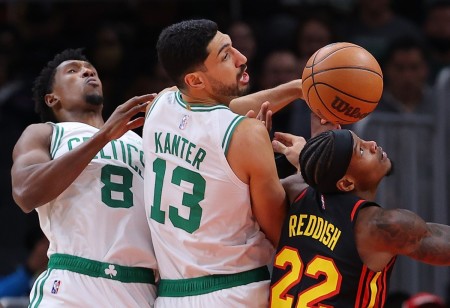Cam Reddish #22 of the Atlanta Hawks battles for a rebound against Enes Kanter #13 and Josh Richardson #8 of the Boston Celtics during the first half at State Farm Arena on November 17, 2021 in Atlanta, Georgia.