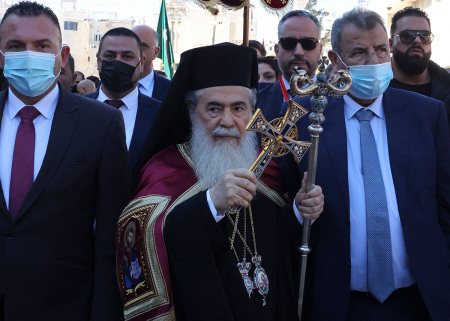 Greek Orthodox Patriarch of Jerusalem Theofilos III (C) arrives at the Church of the Nativity for the Orthodox Christmas celebrations on January 6, 2022, in the biblical West Bank town of Bethlehem, the traditional birthplace of Jesus Christ.
