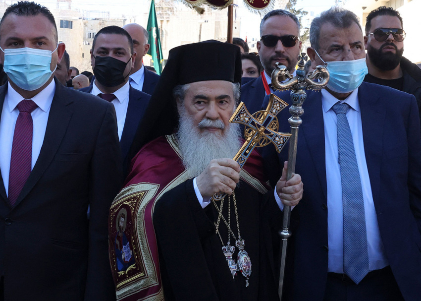 Greek Orthodox Patriarch of Jerusalem Theofilos III (C) arrives at the Church of the Nativity for the Orthodox Christmas celebrations on January 6, 2022, in the biblical West Bank town of Bethlehem, the traditional birthplace of Jesus Christ.