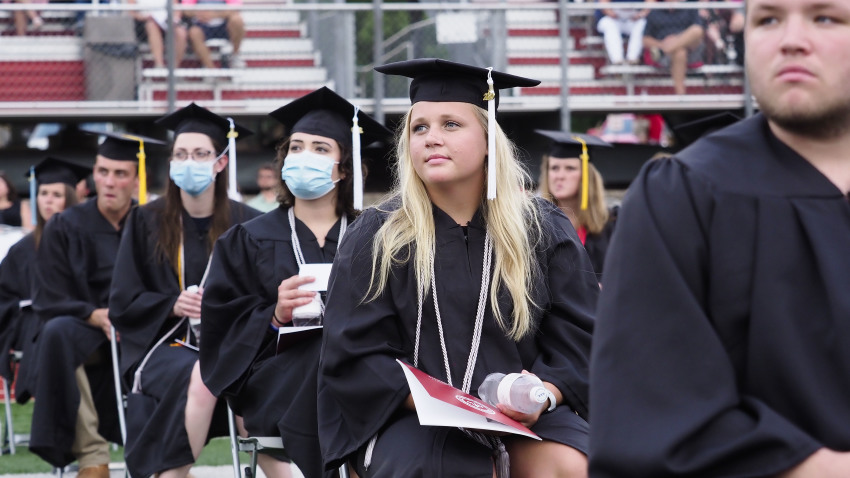 Students attend a commencement ceremony at Northwestern College held at the school's football stadium in Orange City, Iowa in May 2020.