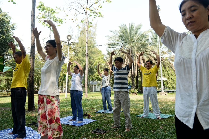 Chinese Falun Gong practitioners and asylum seekers perform Falun Gong exercises in Bangkok, Thailand, on March 14, 2016.