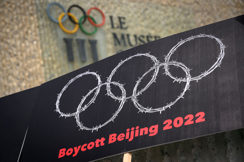 This photograph taken on June 23, 2021, shows a placard representing barber wire shaping and Olympics Rings are seen next to a sign of the Olympics Museum during a protest organised by Tibetan and Uyghur activists against Beijing 2022 Winter Olympics, in Lausanne as some 200 participants took part to the protest.
