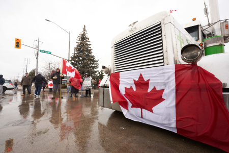 Anti-vaccine mandate protesters block the roadway at the Ambassador Bridge border crossing in Windsor, Ontario, Canada, on February 11, 2022. The protesters supporting the "Freedom Convoy" in Ottawa have blocked traffic in the Canada-bound lanes from the bridge since February 7, 2022.