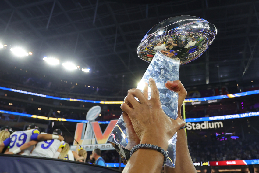 The Vince Lombardi Trophy is held in the air after Super Bowl LVI at SoFi Stadium on February 13, 2022, in Inglewood, California. The Los Angeles Rams defeated the Cincinnati Bengals 23-20.