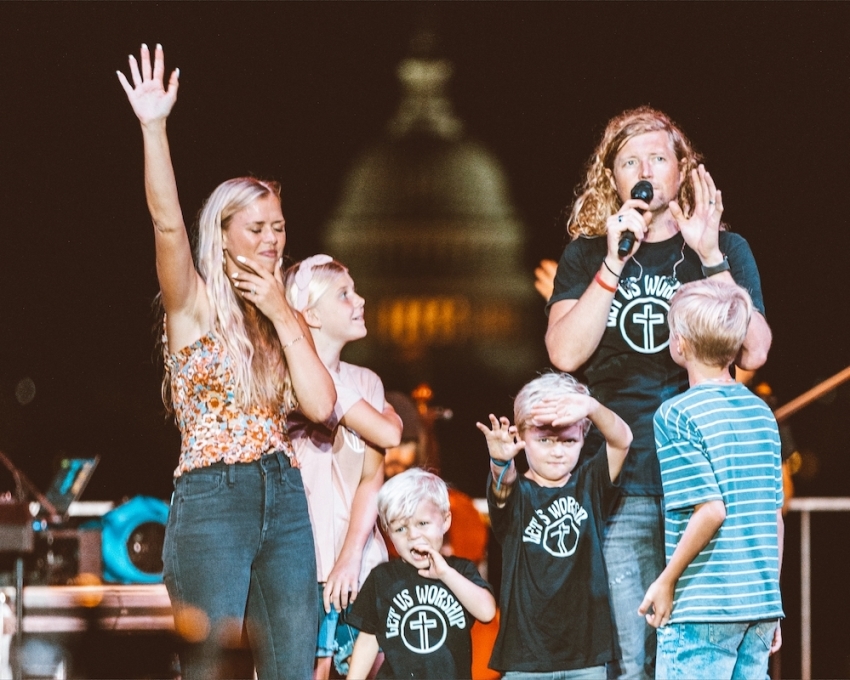 Sean Feucht and family appear on stage during the "Let us Worship" Tour in Washington, D.C. in 2022.