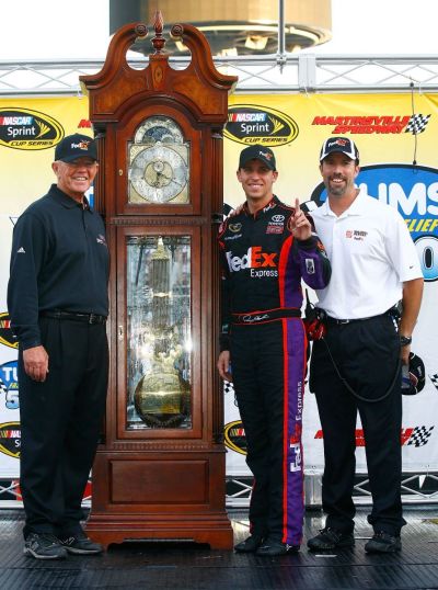 Denny Hamlin, driver of the #11 FedEx Express Toyota, poses with team owners Joe Gibbs and J.D. Gibbs during the NASCAR Sprint Cup Series TUMS Fast Relief 500 at Martinsville Speedway on October 24, 2010 in Martinsville, Virginia.