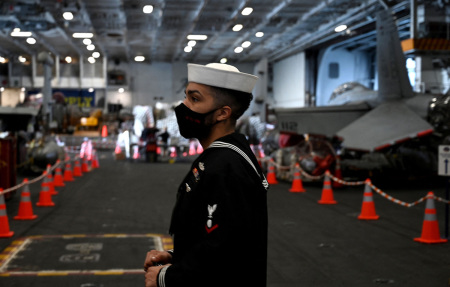 A U.S. Navy sailor stands in the aircraft hanger of the nuclear-powered aircraft carrier USS Harry S. Truman, which arrived on a four-day visit, and is anchored off the city of Split on February 14, 2022.