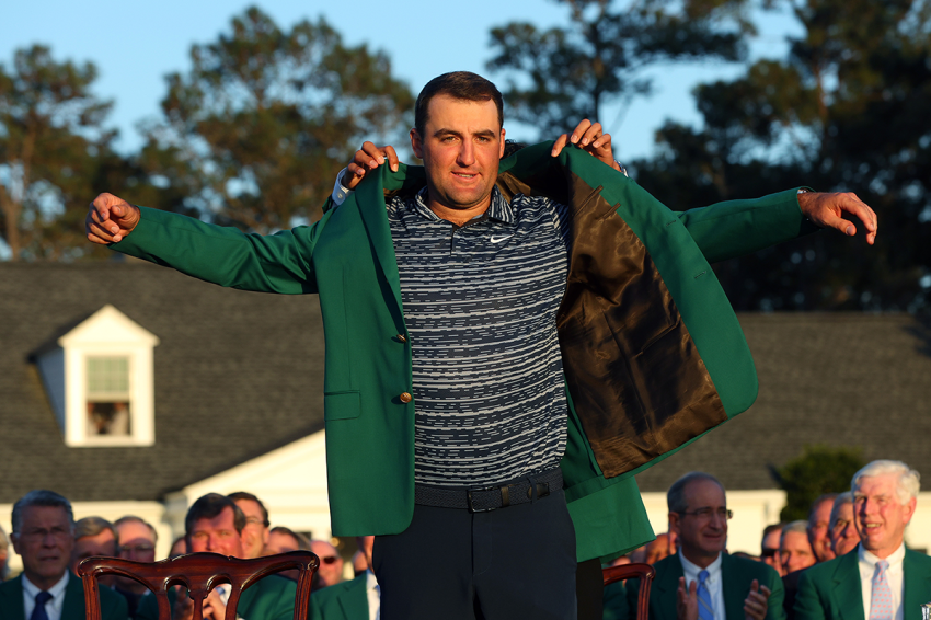 Scottie Scheffler is awarded the Green Jacket by 2021 Masters champion Hideki Matsuyama of Japan during the Green Jacket Ceremony after he won the Masters at Augusta National Golf Club on April 10, 2022, in Augusta, Georgia.