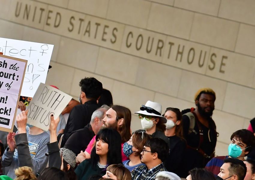 A person holds up a sign reading "Ruth Sent Us" as pro-choice activists gather outside the U.S. Courthouse to defend abortion rights in downtown Los Angeles on May 3, 2022.