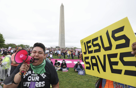 Abortion activist Cristela Luiz (L) confronts a pro-life demonstrator during a Bans Off Our Bodies rally at the base of the Washington Monument on May 14, 2022, in Washington, D.C. Abortion supporters are holding rallies around the country urging lawmakers to affirm abortion rights into law after a leaked draft from the U.S. Supreme Court revealed a potential decision to overturn Roe v. Wade.