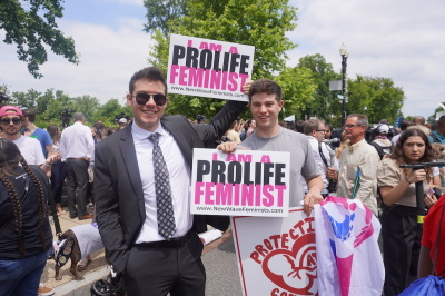 Pro-life feminists held signs high in the air outside the U.S. Supreme Court following the Dobbs v. Jackson Women's Health Organization decision in Washington, D.C., June 24, 2022.