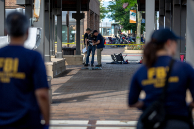 FBI agents work the scene of a shooting at a Fourth of July parade on July 5, 2022 in Highland Park, Illinois. Police have detained Robert “Bobby” E. Crimo III, 22, in connection with the shooting in which six people were killed and 19 injured, according to published reports.