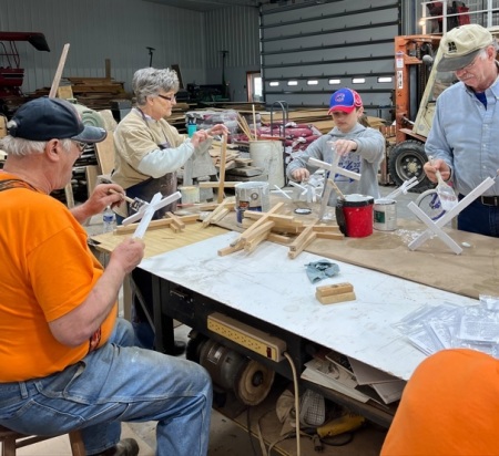 Members of East Jordan United Methodist Church of Sterling, Illinois, make crosses for people to take home and use to spread awareness of the plight of the Ukrainians.