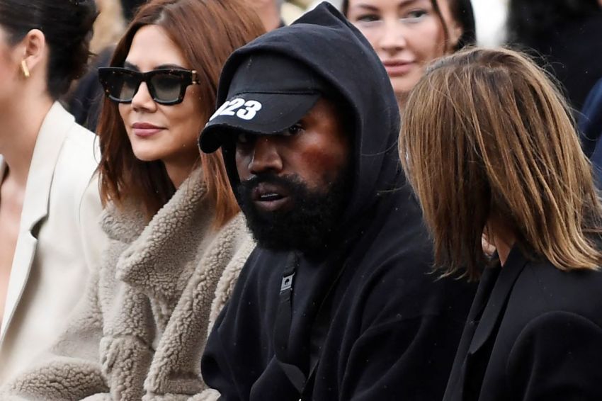 US rapper Kanye West (C) attends the Givenchy Spring-Summer 2023 fashion show during the Paris Womenswear Fashion Week, in Paris on October 2, 2022.