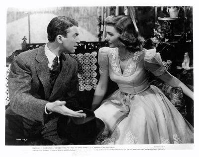 James Stewart sitting and talking with Donna Reed in a scene from the film 'It's A Wonderful Life', 1946.