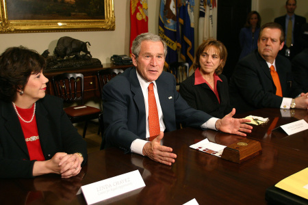 U.S. President George W. Bush (C) gestures as he participates in a meeting in the Roosevelt Room of the White House as Shirley Peckosh (2nd-R), co-owner of Peck's Nursery, Dr. Richard Land (R), president of the Ethics & Religious Liberty Commission and Linda Chavez (L), founder and chairman for the Center for Equal Opportunity listen March 23, 2006, in Washington, D.C. The meeting was held to discuss immigration reform.