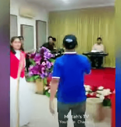Local official Wawan Kurniawan stops worship service in Rajabasa Jaya village, Indonesia, on Feb. 19, 2023.