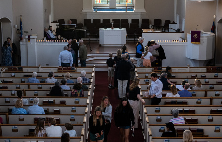 People attend a vigil at Woodmont Christian for those who were killed in a mass shooting at The Covenant School on March 27, 2023, in Nashville, Tennessee. According to initial reports, three students and three adults were killed by the shooter, a 28-year-old woman who self-identified as trans. The shooter was killed by police responding to the scene.