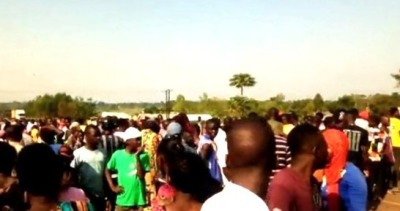 Villagers arrive where the body of Pastor Adinani Bulwa was found on March 11, 2023, in Muterere, Uganda.