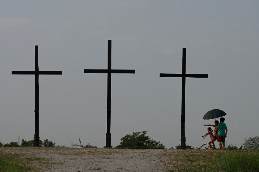 People visit the site where the re-enactment of the crucifixion of Jesus Christ will take place during Holy Week celebrations in San Fernando, Pampanga province on April 4, 2023.
