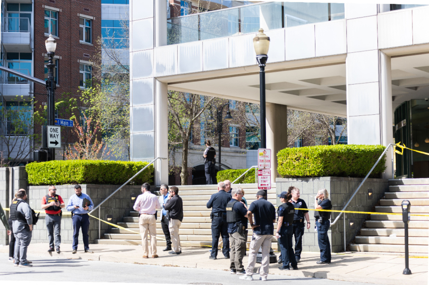 Investigators stand around the area where a shooting occurred in downtown Louisville, Kentucky, on April 10, 2023, leaving five dead, including the gunman, and eight hospitalized.
