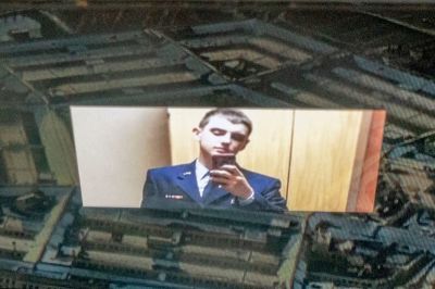 This photo illustration created on April 13, 2023, shows the suspect, national guardsman Jack Teixeira, reflected in an image of the Pentagon in Washington, DC. FBI agents on Thursday arrested a young national guardsman suspected of being behind a major leak of sensitive US government secrets - including about the Ukraine war. US Attorney General Merrick Garland announced the arrest made "in connection with an investigation into alleged unauthorized removal, retention and transmission of classified national defense information."